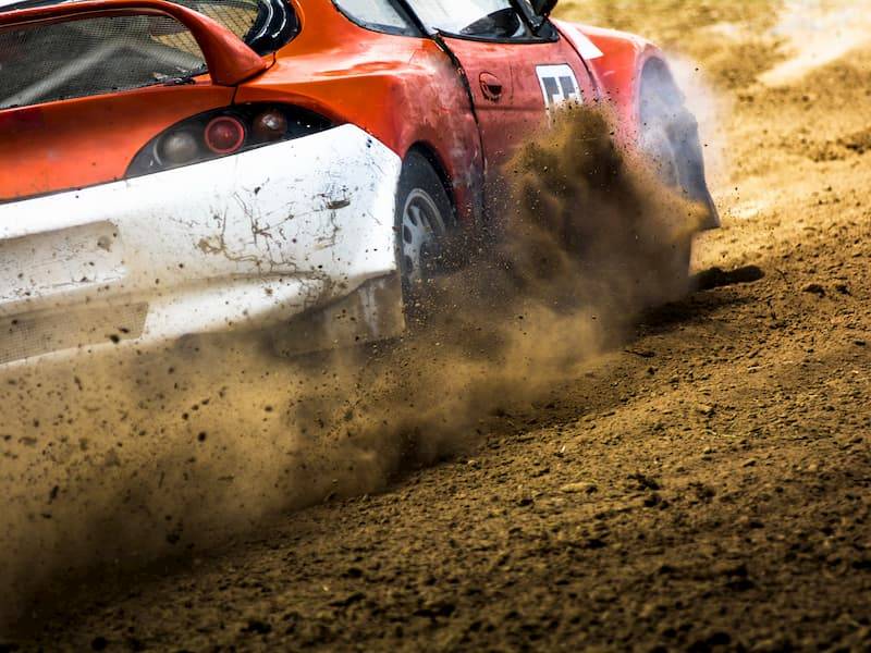 Red And White Rally Car Drifting Creating Dust